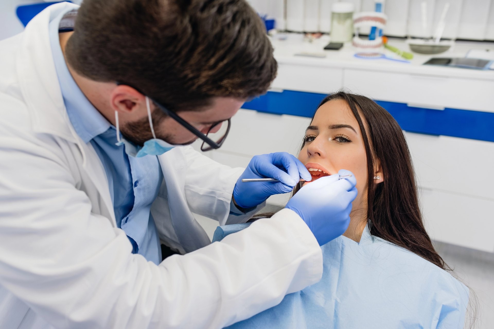 Dentist examining a patient’s teeth with a dental mirror