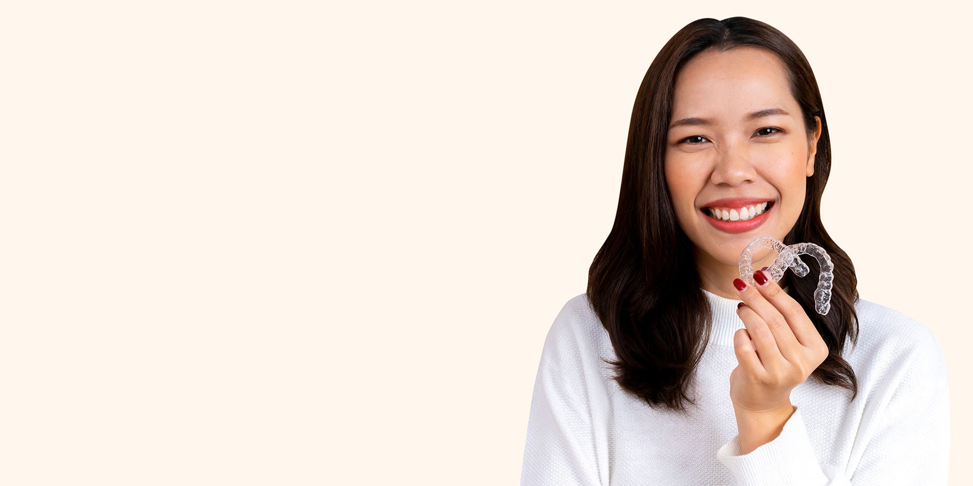 person holding invisalign aligners