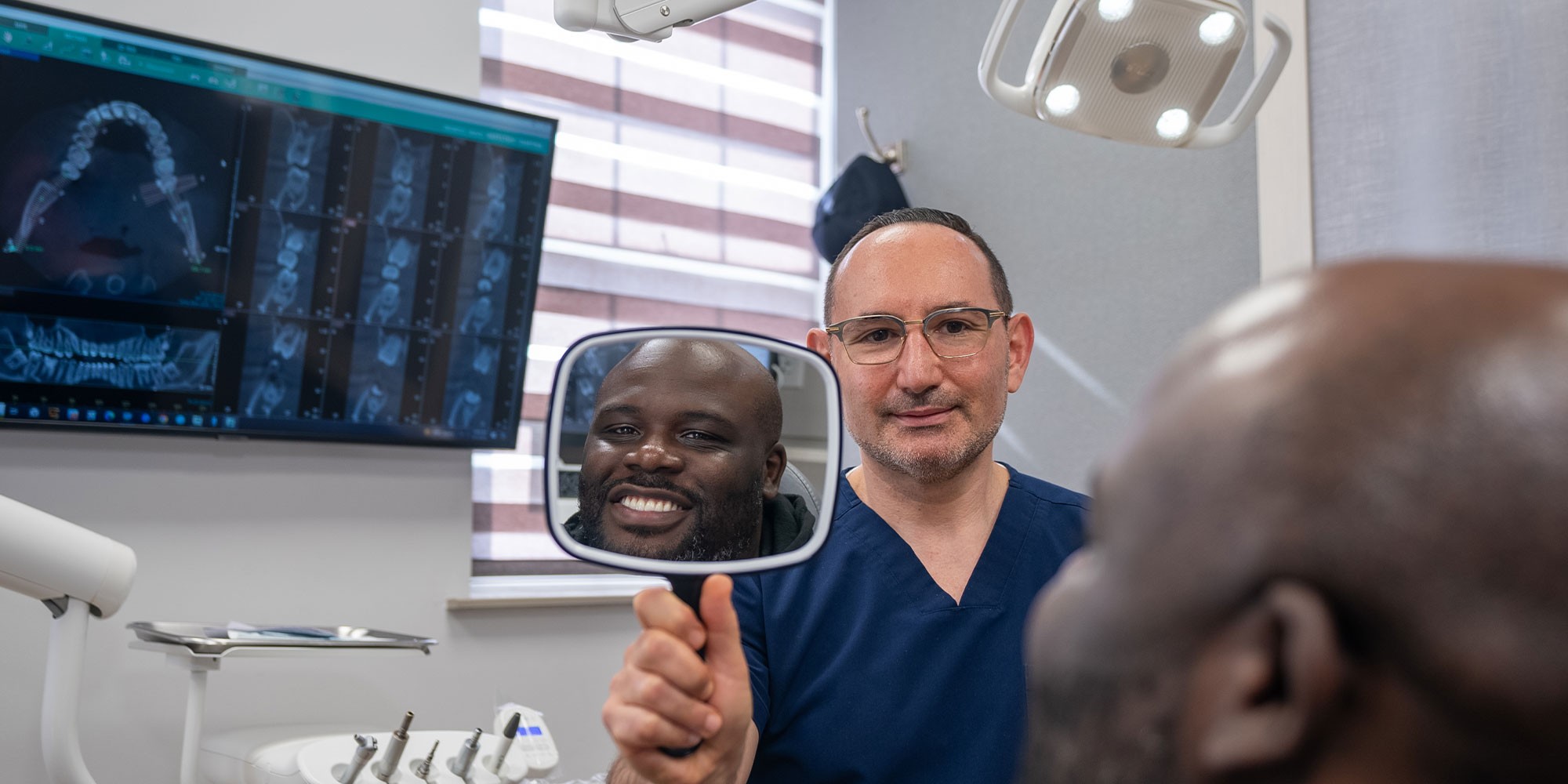 doctor holding a mirror infront of a patient