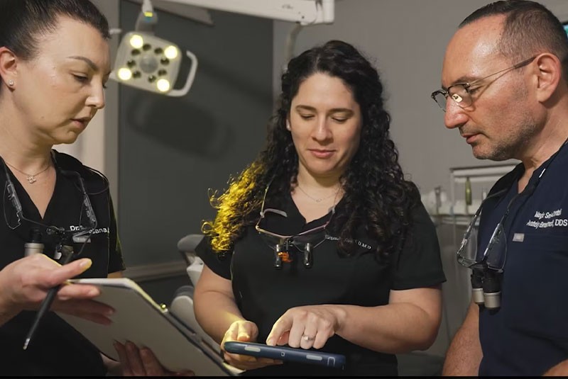 Three doctors discussing in the dental office