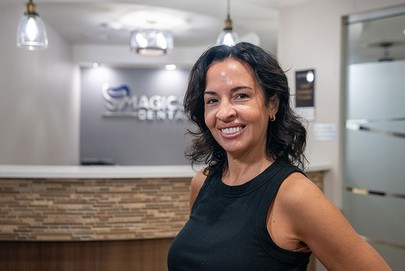 woman smiling standing in magic smile dental office