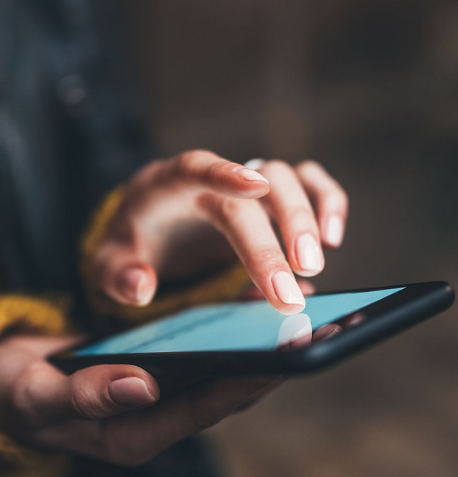 person tapping on a smartphone