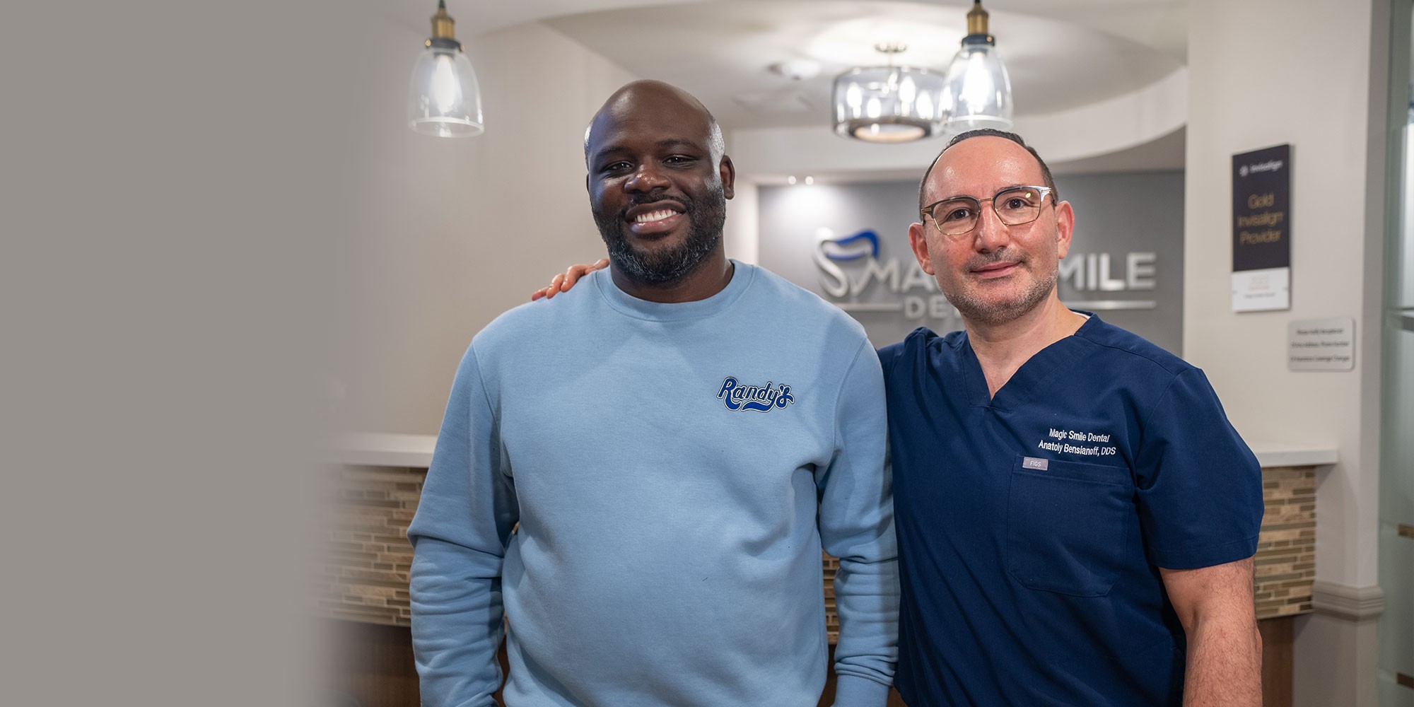 patient standing with doctor in magic smiles dental office