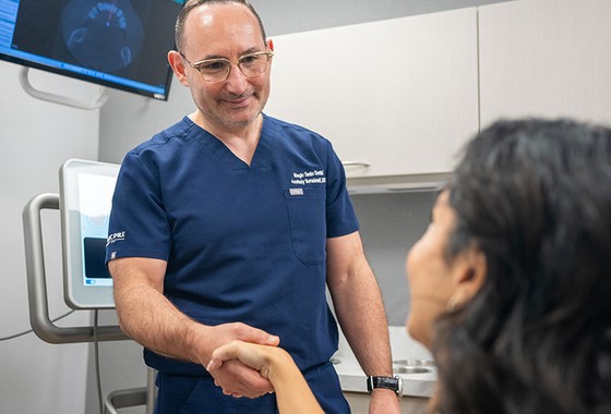 patient shaking hands with a doctor in a dental office