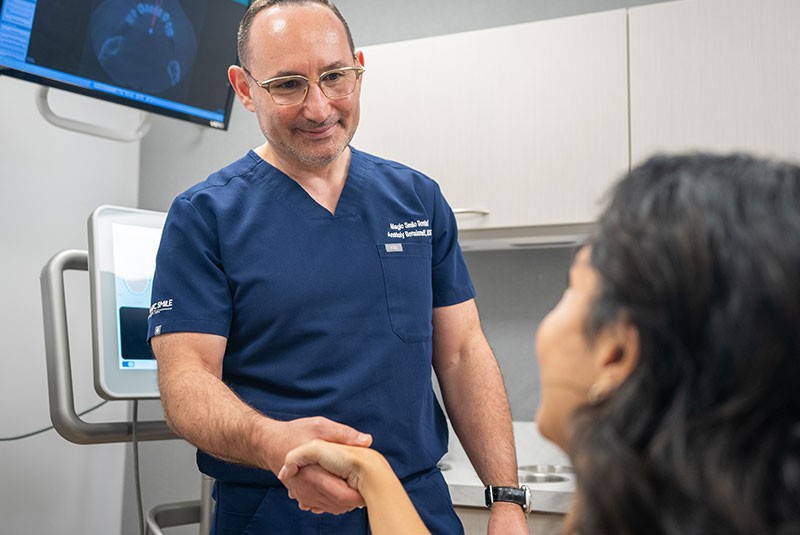 Patient shaking hands with a doctor in the dental office